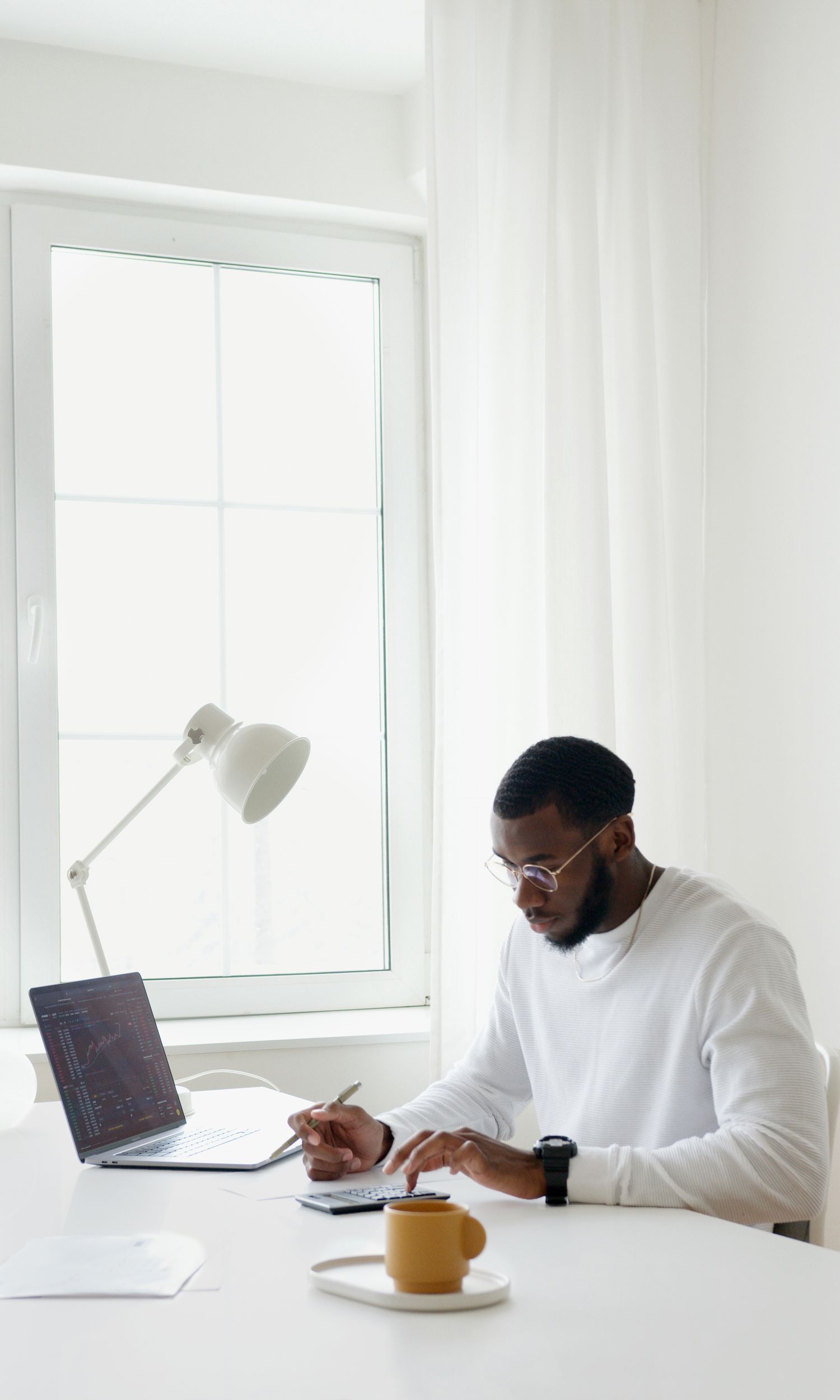 Professional doing focused back-office and data work at a laptop